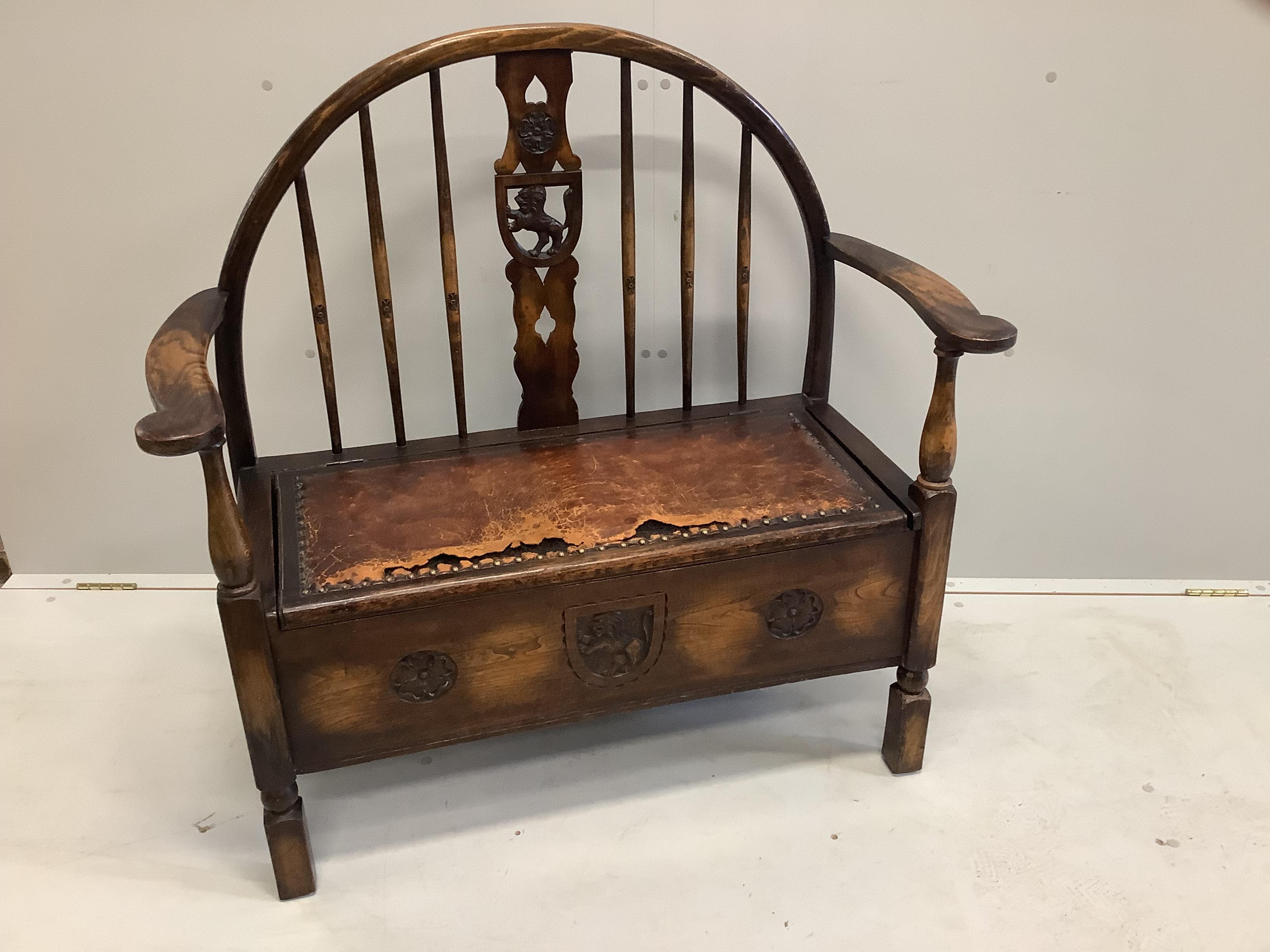 An early 20th century oak and beech hall settle with hinged box seat, width 100cm, depth 46cm, height 100cm